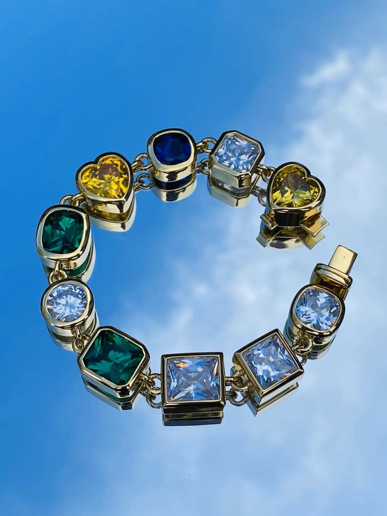 Pharrell Williams grills are studded with sapphires, rubies and emeralds. INFINITY GAUNTLETS jewelry diamond choker jacob & co short necklace gemstone heart Gabby Elan Jewelry infinity stone grillz grill grills