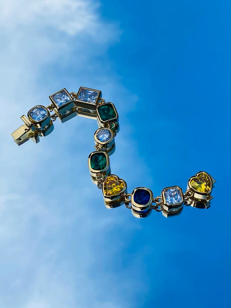Pharrell Williams grills are studded with sapphires, rubies and emeralds. INFINITY GAUNTLETS jewelry diamond choker jacob & co short necklace gemstone heart Gabby Elan Jewelry infinity stone grillz grill grills