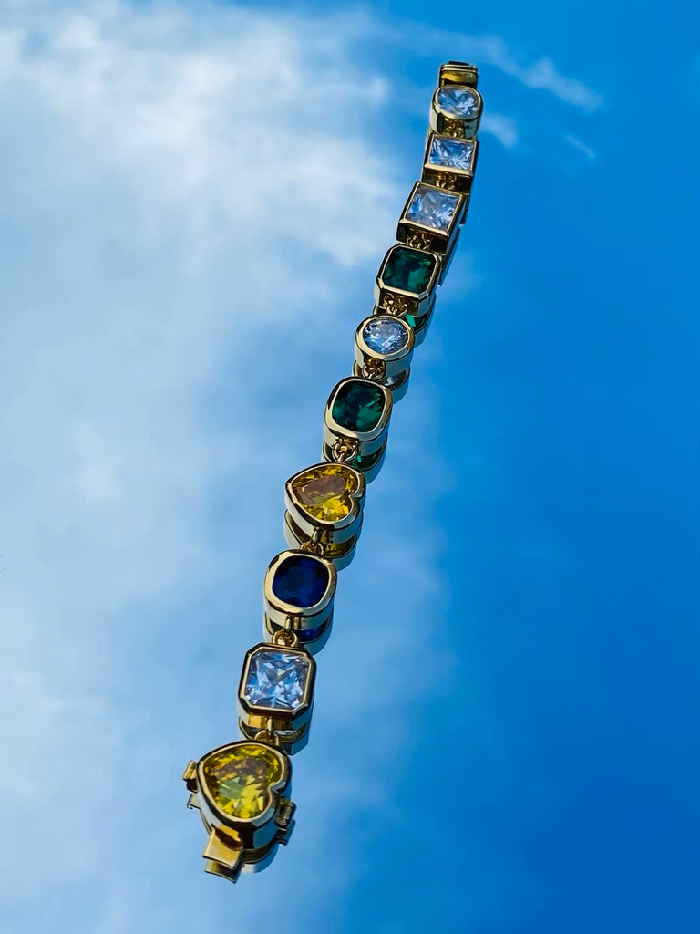 Pharrell Williams grills are studded with sapphires, rubies and emeralds. INFINITY GAUNTLETS jewelry diamond choker jacob & co short necklace gemstone heart Gabby Elan Jewelry infinity stone grillz grill grills