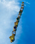 Pharrell Williams grills are studded with sapphires, rubies and emeralds. INFINITY GAUNTLETS jewelry diamond choker jacob & co short necklace gemstone heart Gabby Elan Jewelry infinity stone grillz grill grills