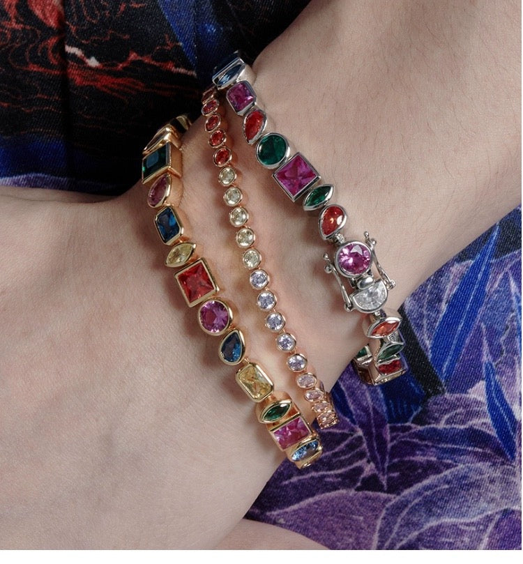 Pharrell Williams grills are studded with sapphires, rubies and emeralds. INFINITY GAUNTLETS jewelry diamond choker jacob & co short necklace gemstone heart Gabby Elan Jewelry infinity stone grillz grill grills