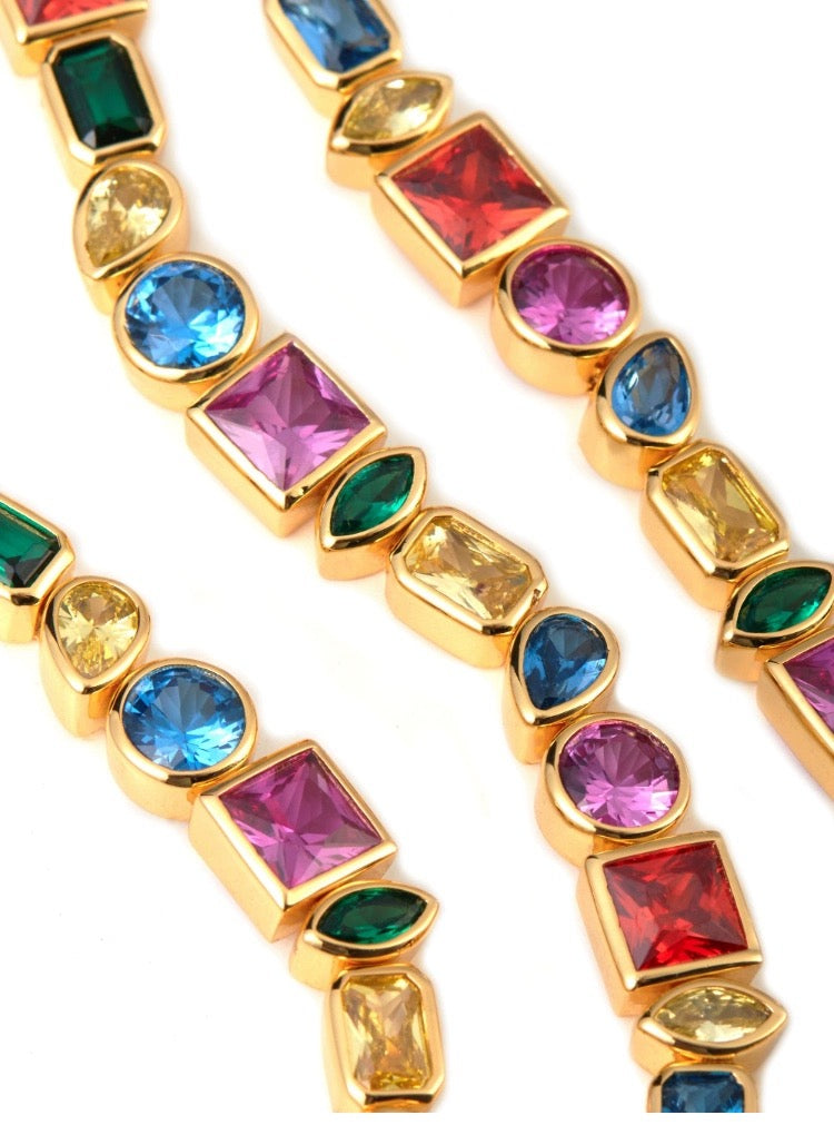 Pharrell Williams grills are studded with sapphires, rubies and emeralds. INFINITY GAUNTLETS jewelry diamond choker jacob & co short necklace gemstone heart Gabby Elan Jewelry infinity stone grillz grill grills
