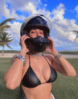 Kim Kardashian took to Instagram wearing a black leather bikini top, a motorcycle helmet, and no pants.