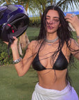 Kim Kardashian took to Instagram wearing a black leather bikini top, a motorcycle helmet, and no pants.