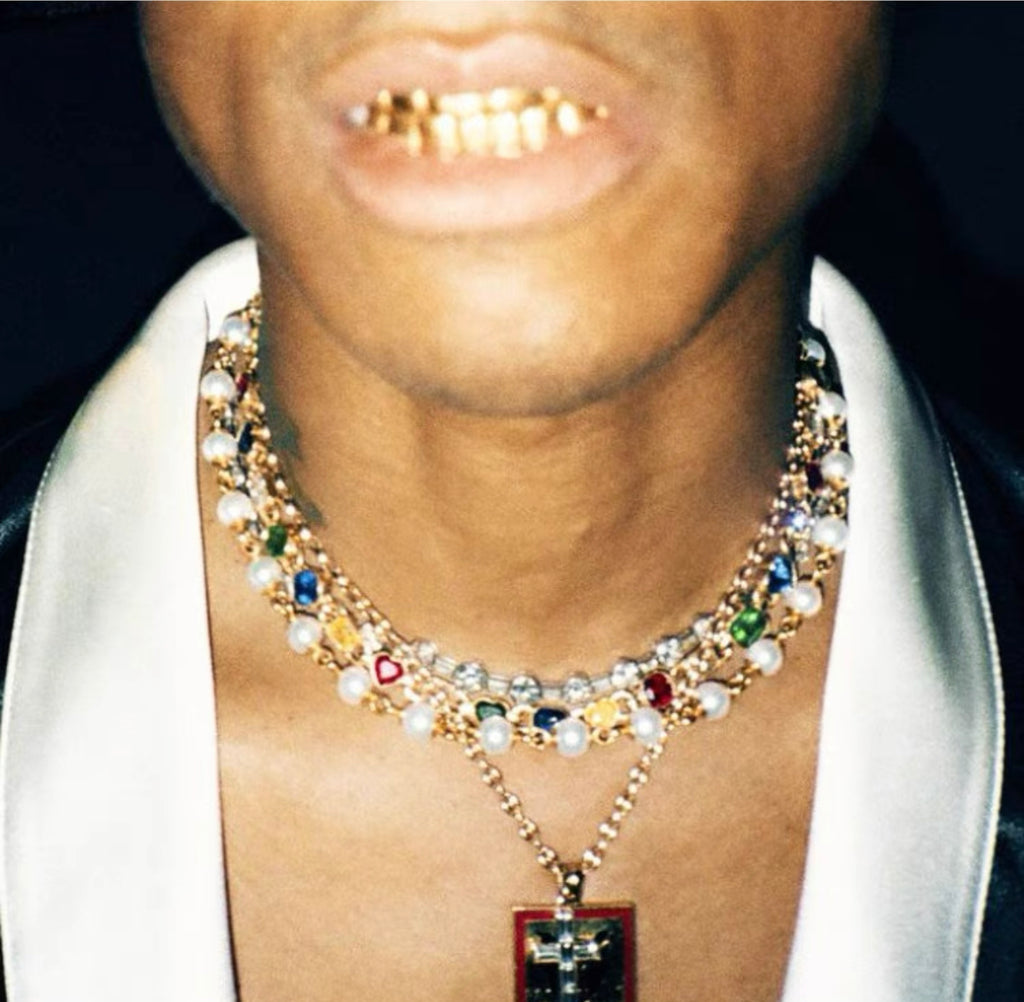 Pharrell Williams grills are studded with sapphires, rubies and emeralds. INFINITY GAUNTLETS jewelry diamond choker jacob & co short necklace gemstone heart Gabby Elan Jewelry infinity stone grillz grill grills