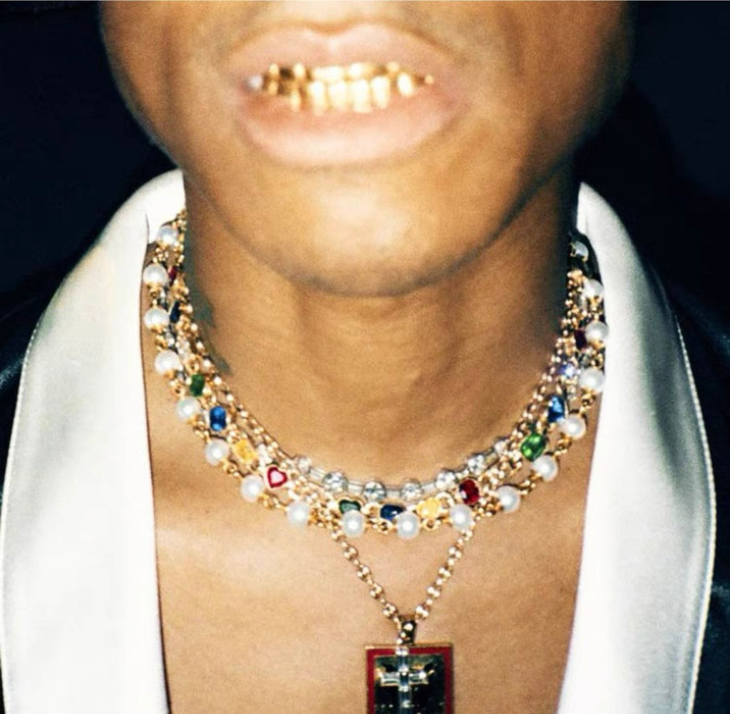 Pharrell Williams grills are studded with sapphires, rubies and emeralds. INFINITY GAUNTLETS jewelry diamond choker jacob & co short necklace gemstone heart Gabby Elan Jewelry infinity stone grillz grill grills