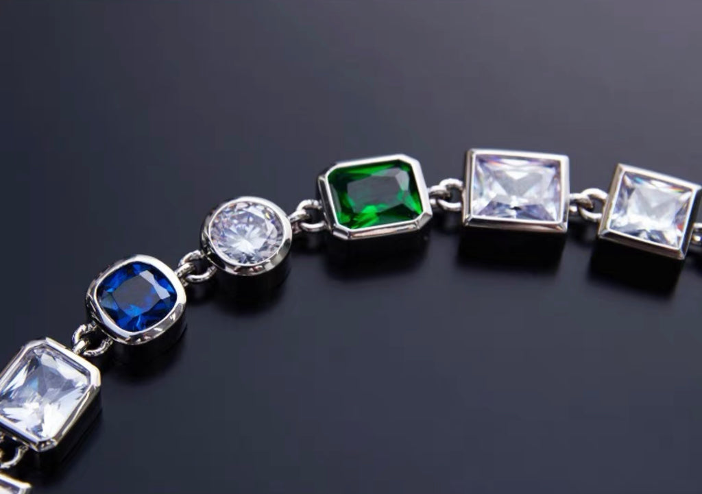 Pharrell Williams grills are studded with sapphires, rubies and emeralds. INFINITY GAUNTLETS jewelry diamond choker jacob & co short necklace gemstone heart Gabby Elan Jewelry infinity stone grillz grill grills