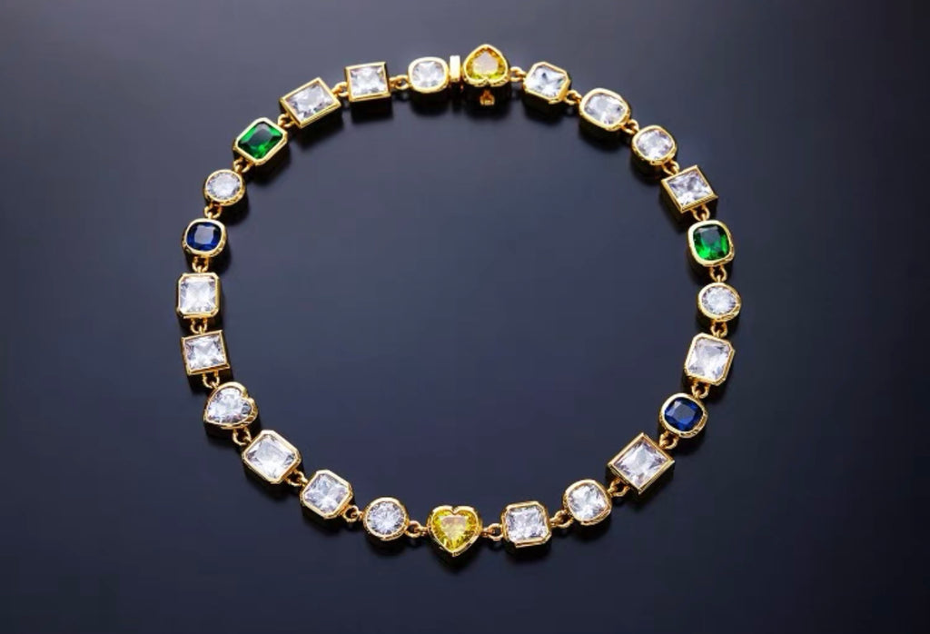 Pharrell Williams grills are studded with sapphires, rubies and emeralds. INFINITY GAUNTLETS jewelry diamond choker jacob & co short necklace gemstone heart Gabby Elan Jewelry infinity stone grillz grill grills