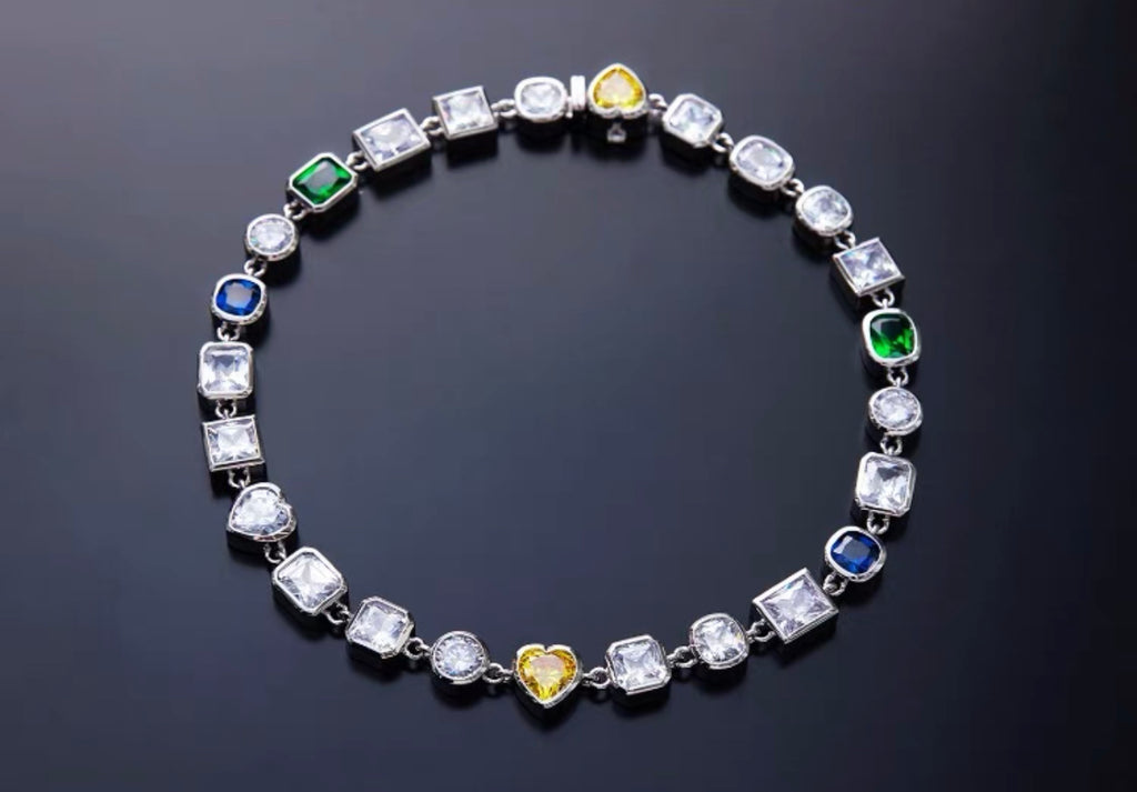 Pharrell Williams grills are studded with sapphires, rubies and emeralds. INFINITY GAUNTLETS jewelry diamond choker jacob & co short necklace gemstone heart Gabby Elan Jewelry infinity stone grillz grill grills
