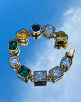 Pharrell Williams grills are studded with sapphires, rubies and emeralds. INFINITY GAUNTLETS jewelry diamond choker jacob & co short necklace gemstone heart Gabby Elan Jewelry infinity stone grillz grill grills