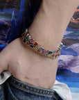 Pharrell Williams grills are studded with sapphires, rubies and emeralds. INFINITY GAUNTLETS jewelry diamond choker jacob & co short necklace gemstone heart Gabby Elan Jewelry infinity stone grillz grill grills
