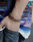 Pharrell Williams grills are studded with sapphires, rubies and emeralds. INFINITY GAUNTLETS jewelry diamond choker jacob & co short necklace gemstone heart Gabby Elan Jewelry infinity stone grillz grill grills