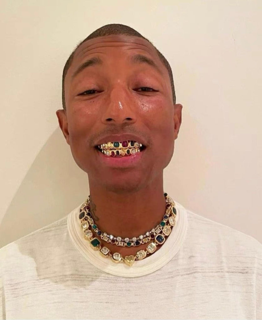 Pharrell Williams grills are studded with sapphires, rubies and emeralds. INFINITY GAUNTLETS jewelry diamond choker jacob & co short necklace gemstone heart Gabby Elan Jewelry infinity stone grillz grill grills