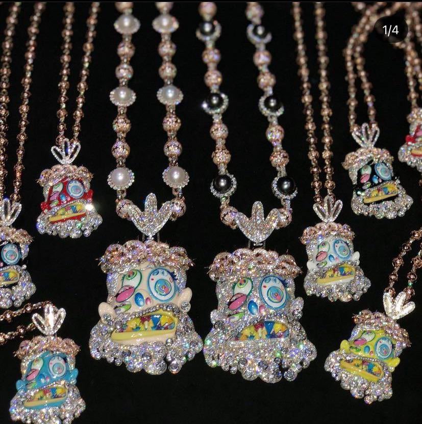 Travis Scott recently got pretty generous with his team, gifting his inner circle iced-out Takashi Murakami-designed chains from Eliantte