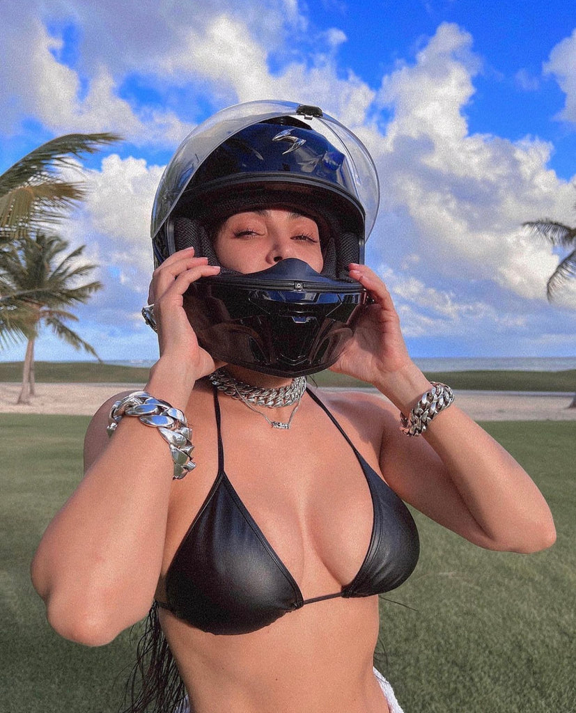 Kim Kardashian took to Instagram wearing a black leather bikini top, a motorcycle helmet, and no pants.