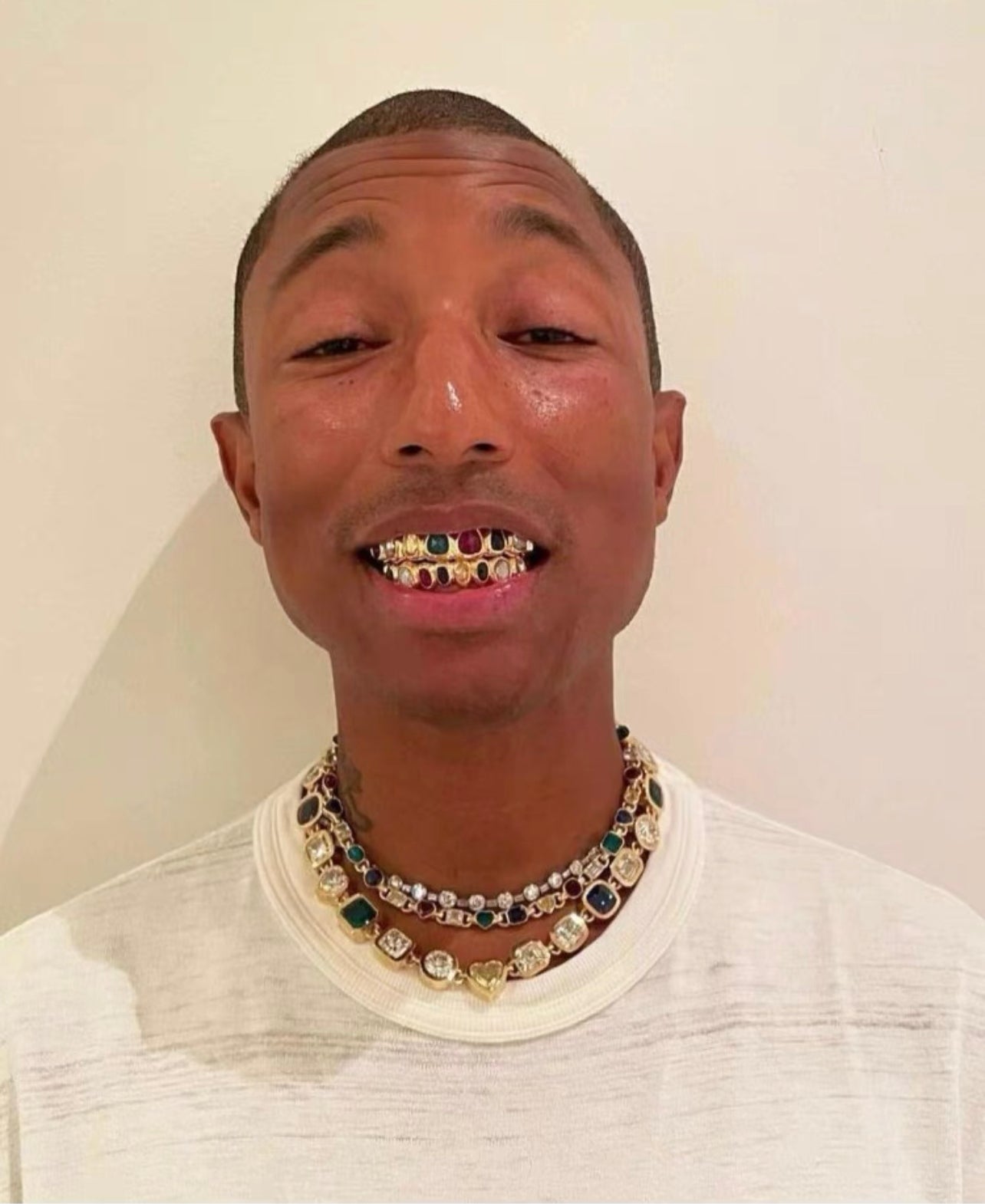 Pharrell Williams grills are studded with sapphires, rubies and emeralds. INFINITY GAUNTLETS jewelry diamond choker jacob &amp; co short necklace gemstone heart Gabby Elan Jewelry infinity stone grillz grill grills
