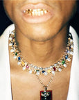 Pharrell Williams grills are studded with sapphires, rubies and emeralds. INFINITY GAUNTLETS jewelry diamond choker jacob & co short necklace gemstone heart Gabby Elan Jewelry infinity stone grillz grill grills
