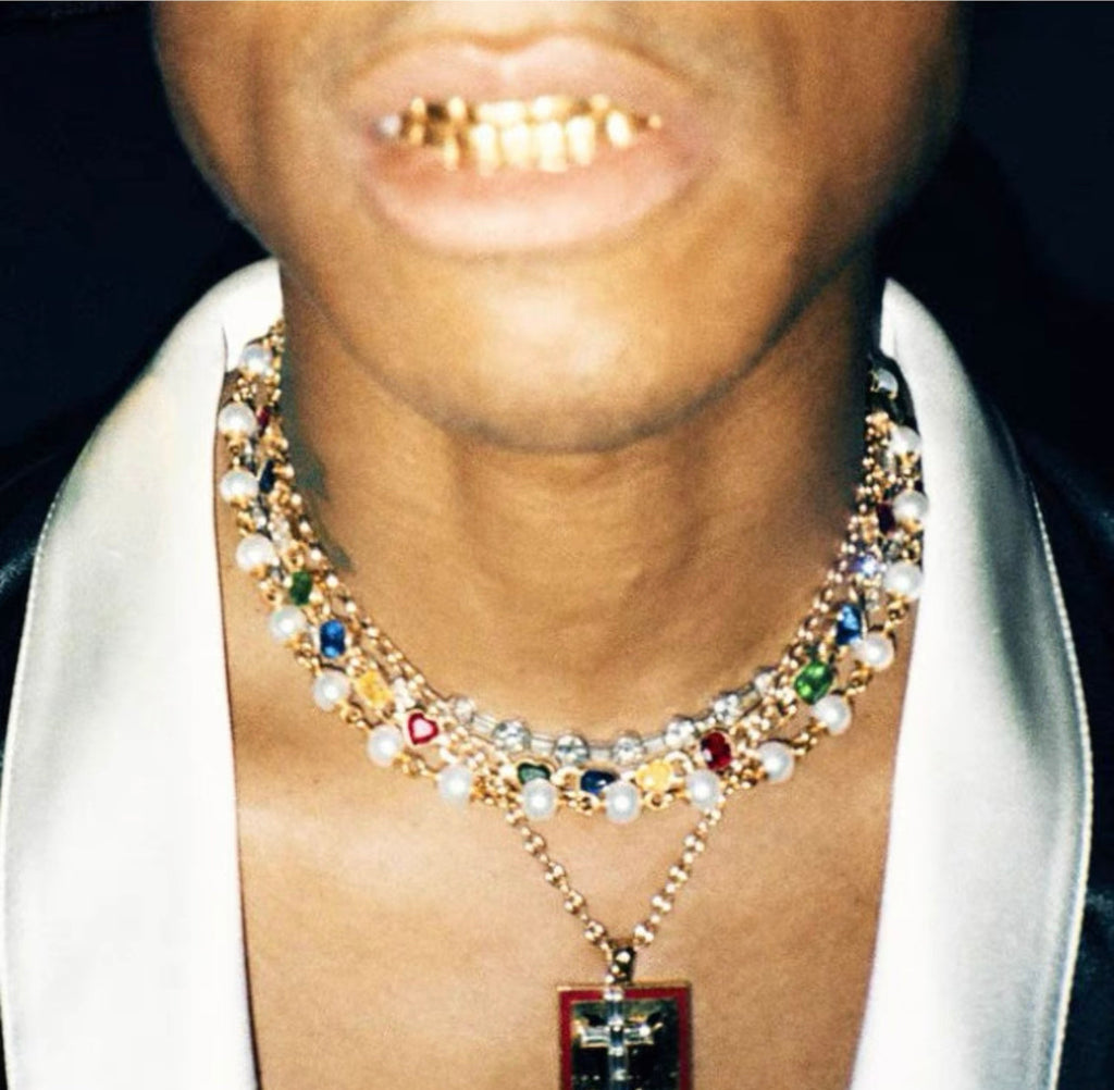 Pharrell Williams grills are studded with sapphires, rubies and emeralds. INFINITY GAUNTLETS jewelry diamond choker jacob & co short necklace gemstone heart Gabby Elan Jewelry infinity stone grillz grill grills