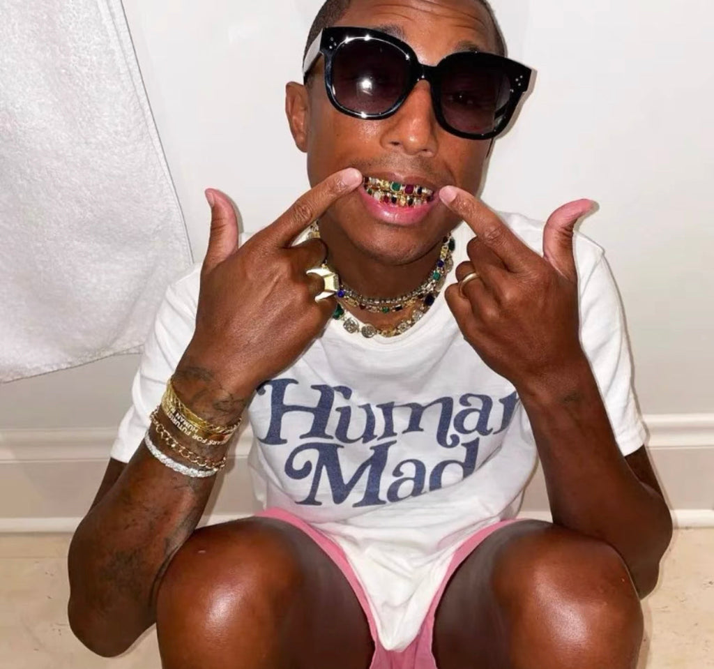 Pharrell Williams grills are studded with sapphires, rubies and emeralds. INFINITY GAUNTLETS jewelry diamond choker jacob & co short necklace gemstone heart Gabby Elan Jewelry infinity stone grillz grill grills
