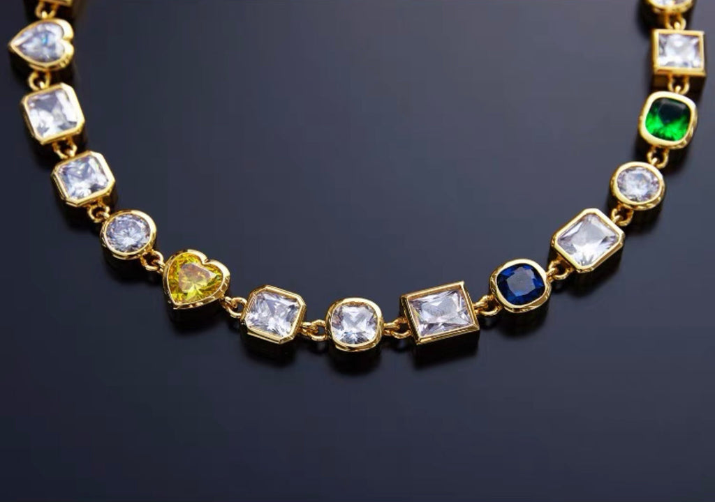 Pharrell Williams grills are studded with sapphires, rubies and emeralds. INFINITY GAUNTLETS jewelry diamond choker jacob & co short necklace gemstone heart Gabby Elan Jewelry infinity stone grillz grill grills