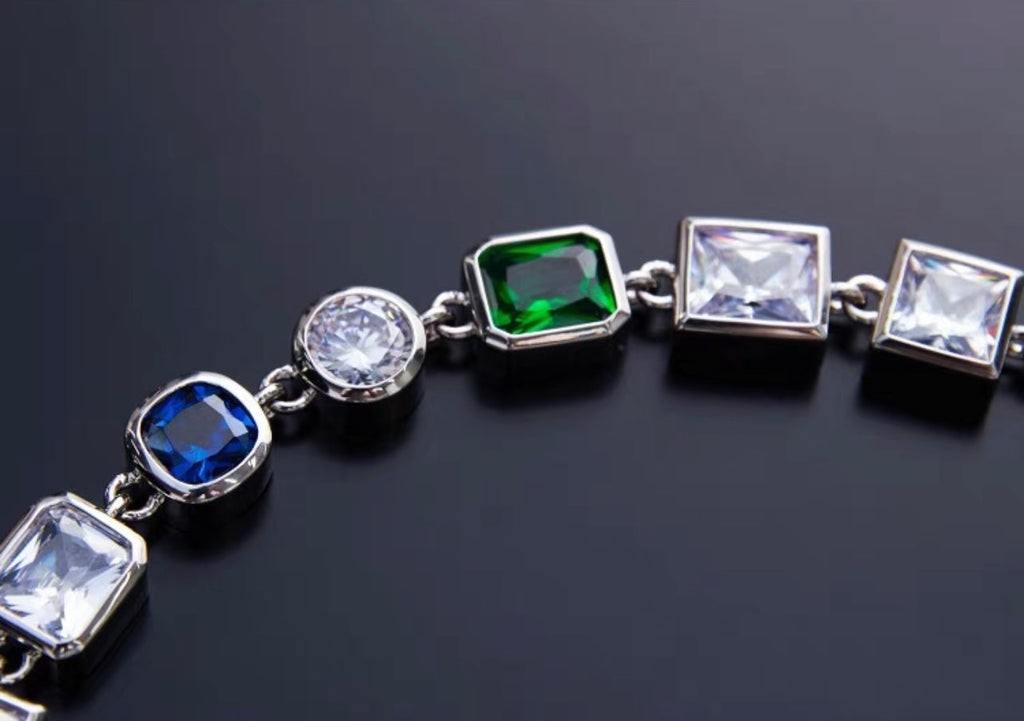 Pharrell Williams grills are studded with sapphires, rubies and emeralds. INFINITY GAUNTLETS jewelry diamond choker jacob & co short necklace gemstone heart Gabby Elan Jewelry infinity stone grillz grill grills