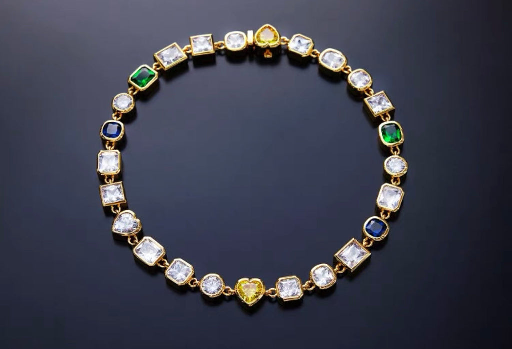 Pharrell Williams grills are studded with sapphires, rubies and emeralds. INFINITY GAUNTLETS jewelry diamond choker jacob & co short necklace gemstone heart Gabby Elan Jewelry infinity stone grillz grill grills