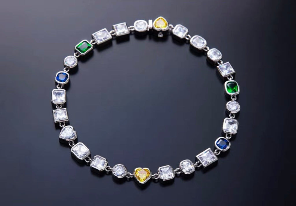 Pharrell Williams grills are studded with sapphires, rubies and emeralds. INFINITY GAUNTLETS jewelry diamond choker jacob & co short necklace gemstone heart Gabby Elan Jewelry infinity stone grillz grill grills