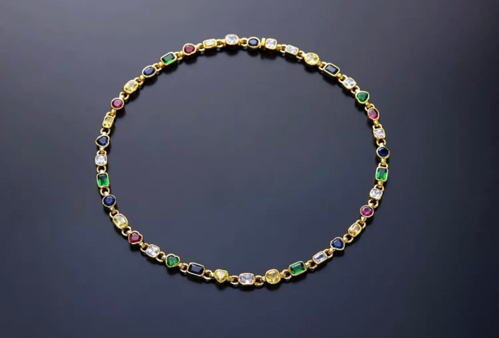 Pharrell Williams grills are studded with sapphires, rubies and emeralds. INFINITY GAUNTLETS jewelry diamond choker jacob & co short necklace gemstone heart Gabby Elan Jewelry infinity stone grillz grill grills