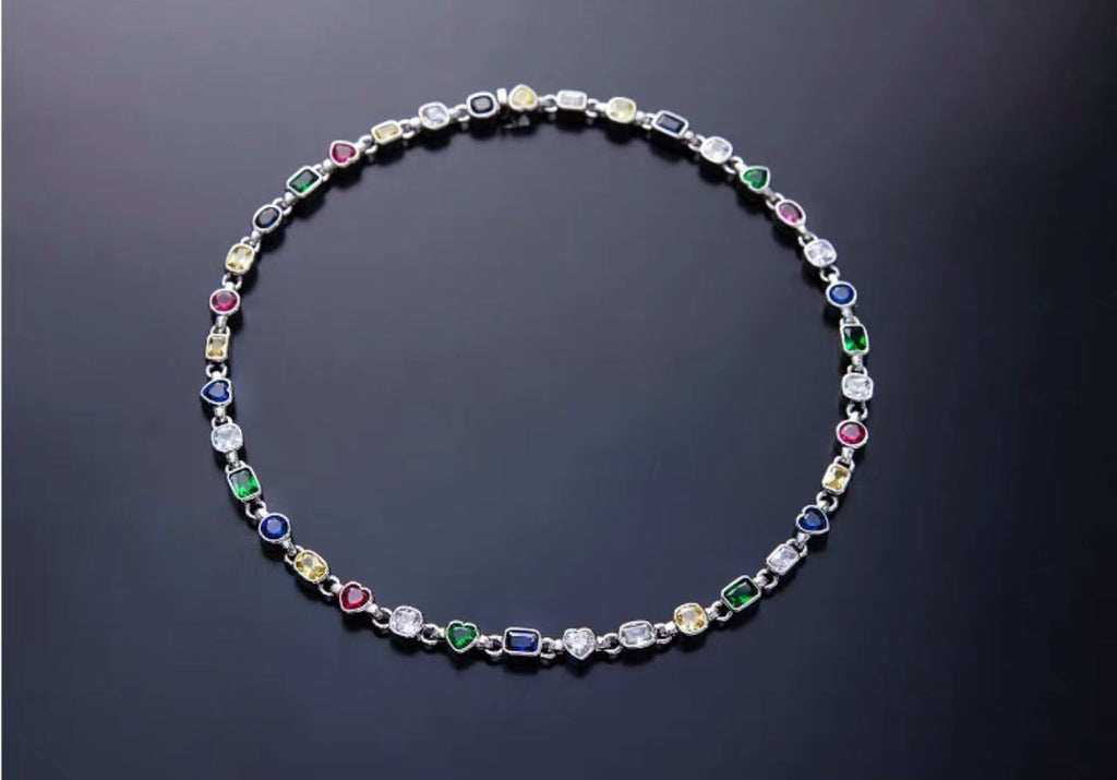 Pharrell Williams grills are studded with sapphires, rubies and emeralds. INFINITY GAUNTLETS jewelry diamond choker jacob & co short necklace gemstone heart Gabby Elan Jewelry infinity stone grillz grill grills