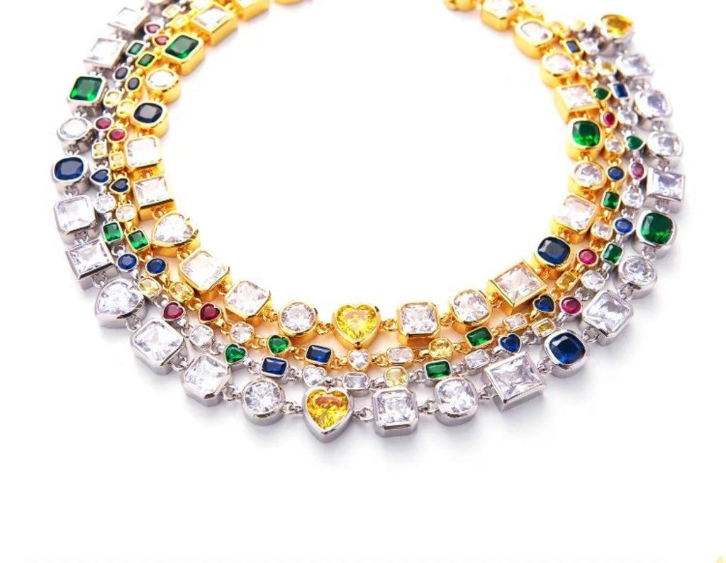 Pharrell Williams grills are studded with sapphires, rubies and emeralds. INFINITY GAUNTLETS jewelry diamond choker jacob & co short necklace gemstone heart Gabby Elan Jewelry infinity stone grillz grill grills