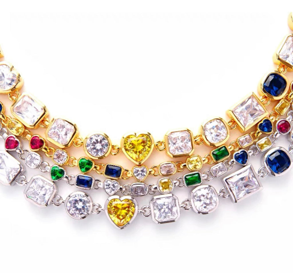 Pharrell Williams grills are studded with sapphires, rubies and emeralds. INFINITY GAUNTLETS jewelry diamond choker jacob & co short necklace gemstone heart Gabby Elan Jewelry infinity stone grillz grill grills