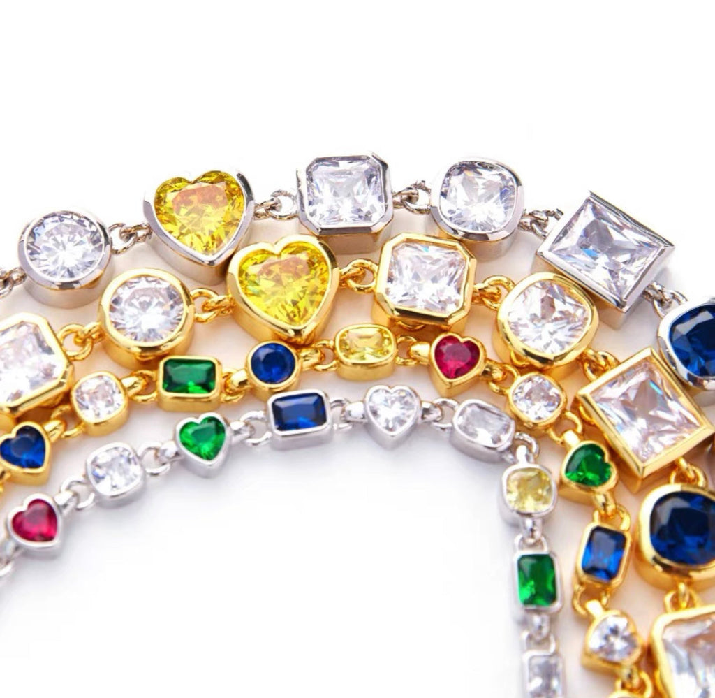 Pharrell Williams grills are studded with sapphires, rubies and emeralds. INFINITY GAUNTLETS jewelry diamond choker jacob & co short necklace gemstone heart Gabby Elan Jewelry infinity stone grillz grill grills